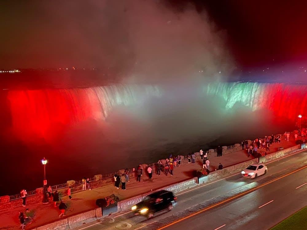 The Niagara falls lit up like the Canadian flag.